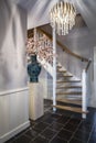 Luxurious hallway with beautiful chandelier and antique vase