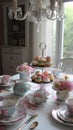 Luxurious high tea party in a classic elegant interior with sweets and tea, tablescape, tea table setting. Generative Ai Royalty Free Stock Photo