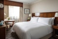 luxurious hotel room, with freshly laundered linens and crisp white sheets on the bed Royalty Free Stock Photo