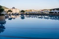 Luxurious hotel with swimming pool, palm trees, sun loungers Royalty Free Stock Photo