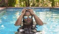 Luxurious Indian Lady Swimming in Pool wearing Sunglass on Weekend Vacation Royalty Free Stock Photo