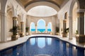 luxurious indoor swimming pool in Moroccan Arab style equipped with columns and exclusive furniture in a luxury villa Royalty Free Stock Photo