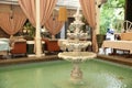 The luxurious interior of the restaurant with a beautiful fountain with bottles of champagne in the fountain.