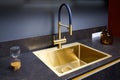 Luxurious interior square golden brass sink and faucet double tap mixer in contemporary modern design with stone marble