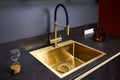 Luxurious interior square golden brass sink and faucet double tap mixer in contemporary modern design with stone marble