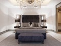 Luxurious large double bed in gray fabric with pillows and striped duvet with black bedside tables and black table lamps