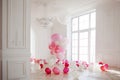 Luxurious living room with large window to the floor. Palace is filled with pink balloons Royalty Free Stock Photo