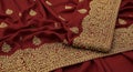 Luxurious Maroon Saree Fabric with Golden Zari Work Royalty Free Stock Photo