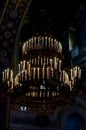 Massive golden chandelier in dark cathedral