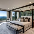 A luxurious master bedroom with a canopy bed, a cozy sitting area by the fireplace, and floor-to-ceiling windows overlooking a s Royalty Free Stock Photo