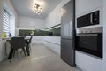 White modern kitchen with granite counter top and marble floor Royalty Free Stock Photo