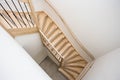 Luxurious modern wooden staircase with curved landing wall in a house Royalty Free Stock Photo