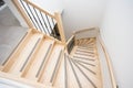 Luxurious modern wooden staircase with curved landing wall in a house Royalty Free Stock Photo