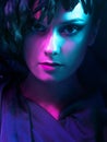 Luxurious mystical portrait, femme fatale in neon light. Portrait of a beautiful young girl
