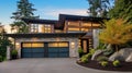 Luxurious new construction home in Bellevue, WA. Modern style home boasts two car garage framed by blue siding and natural stone Royalty Free Stock Photo