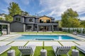 Luxurious outdoor area featuring a pool surrounded by plush lounge chairs