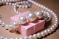 Luxurious pearl jewelry on a pink box. Snow-white pearls. Bijouterie. Jewelry. Pearl beads. Women`s jewelry. Royalty Free Stock Photo