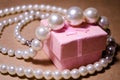 Luxurious pearl jewelry on a pink box. Snow-white pearls. Bijouterie. Jewelry. Pearl beads. Women`s jewelry. Royalty Free Stock Photo