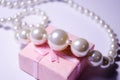 Luxurious pearl jewelry on a pink box. Snow-white pearls. Bijouterie. Jewelry. Snow-white beads on a white background. Brilliant p Royalty Free Stock Photo