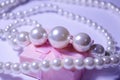 Luxurious pearl jewelry on a pink box. Snow-white pearls. Bijouterie. Jewelry. Snow-white beads on a white background. Brilliant p Royalty Free Stock Photo