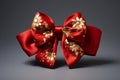 Luxurious red bow with golden floral patterns on minimal dark background Royalty Free Stock Photo