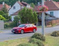 Luxurious red car Honda Civic on the road of a small town