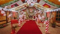 Luxurious red chair Santa Claus throne surrounded by multiple gi