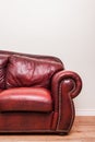 Luxurious Red Leather Couch in front of a blank wall Royalty Free Stock Photo