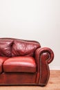 Luxurious Red Leather Couch in front of a blank wall Royalty Free Stock Photo