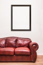Luxurious Red Leather Couch in front of a blank wall Royalty Free Stock Photo