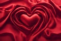 Luxurious red satin heart on silk fabric background. Royalty Free Stock Photo