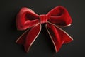 A luxurious red velvet bow with gold trim on a dark background Royalty Free Stock Photo
