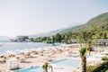 Luxurious sandy beach with sun loungers and white parasols at the One and Only Hotel. Portonovi, Montenegro Royalty Free Stock Photo