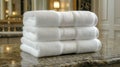 Luxurious Spa Experience at Home Stack of fluffy white towels on a marble bathroom vanity. Royalty Free Stock Photo