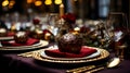 table setting with a red napkin, gold-rimmed plates, ornate bauble, gold cutlery, and wine glasses, against a blurred Royalty Free Stock Photo