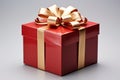 Luxurious touch: Gleaming red gift box, adorned with golden ribbon and bow.