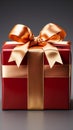 Luxurious touch: Gleaming red gift box, adorned with golden ribbon and bow.