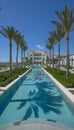 Luxurious tropical resort swimming pool with beautiful surroundings on a sunny day Royalty Free Stock Photo