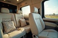 Luxurious van interior features comfortable leather seats and decorative pillows. The elegant design emphasizes a premium, modern Royalty Free Stock Photo