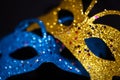 Luxurious Venetian shiny masks on a dark background. Carnival masquerade fantasy mask. Holiday and party concept. Blurred photo