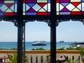 A luxurious view from the hotel window of floating ships at sea and the distant horizon. Tourist directions and travel