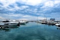 A luxurious view of the sea with a reflection of the clouds. Moored white yachts. Harbour. Port. Russia, Sochi 12.26.2019