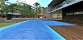 Luxurious villa with a pool on a wooden terrace in the courtyard of ancient buildings in the historic district of Bali. 3d Royalty Free Stock Photo