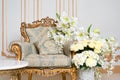 Luxurious vintage interior in the aristocratic style with elegant armchair and flowers. Retro, classics.