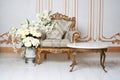 Luxurious vintage interior in the aristocratic style with elegant armchair and flowers. Retro, classics.