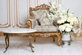 Luxurious vintage interior in the aristocratic style with elegant armchair and flowers. Retro, classics.