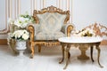 Luxurious vintage interior in the aristocratic style with elegant armchair and flowers. Retro, classics.