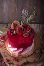 Luxurious wedding or St. Valentine`s cake of burgundy and red shades decorated with juicy strawberries Royalty Free Stock Photo