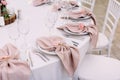 Luxurious wedding table decoration for reception of guests with stylish napkins, cute natural flower Royalty Free Stock Photo