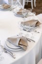 Luxurious wedding table decoration for reception of guests with stylish napkins, cute natural flower Royalty Free Stock Photo